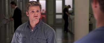 Movie still from “Joy Ride” (2001), directed by John Dahl – A man standing in front of a kitchen sink; Close Up shot, Over the shoulder angle