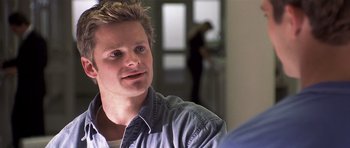 Movie still from “Joy Ride” (2001), directed by John Dahl – A man sitting in front of another man in a room; Close Up shot, Over the shoulder angle