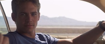 Movie still from “Joy Ride” (2001), directed by John Dahl – A man sitting in the back seat of a car looking out the window; Close Up shot, Over the shoulder angle