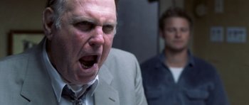 Movie still from “Joy Ride” (2001), directed by John Dahl – A man in a suit and tie with his mouth wide open; Close Up shot, Low angle