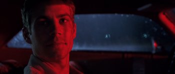 Movie still from “Joy Ride” (2001), directed by John Dahl – A person in a car at night; Close Up shot, Over the shoulder angle