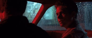 Movie still from “Joy Ride” (2001), directed by John Dahl – A man sitting in the driver's seat of a car in the rain; Close Up shot, Over the shoulder angle