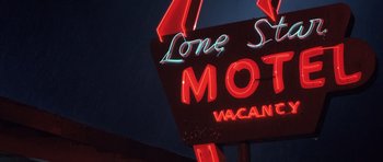 Movie still from “Joy Ride” (2001), directed by John Dahl – View of a neon sign for lone star motel; Wide shot, Low angle
