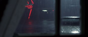 Movie still from “Joy Ride” (2001), directed by John Dahl – A motel sign in the rain at night time; Wide shot, Low angle