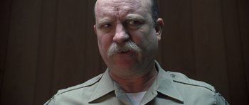 Movie still from “Joy Ride” (2001), directed by John Dahl – A person with a mustache; Close Up shot, Low angle