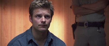 Movie still from “Joy Ride” (2001), directed by John Dahl – A person wearing a blue shirt; Close Up shot, Over the shoulder angle