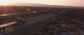 Movie still from “Joy Ride” (2001), directed by John Dahl – A view of a highway at sunset with a truck in the middle of the road; Extreme Wide shot, High angle