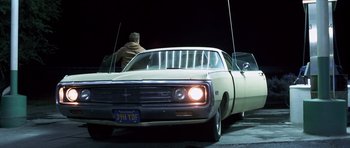 Movie still from “Joy Ride” (2001), directed by John Dahl – An old car is parked on the side of the road; Wide shot, Low angle