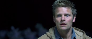 Movie still from “Joy Ride” (2001), directed by John Dahl – A person wearing a jacket; Close Up shot, Over the shoulder angle