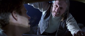 Movie still from “Joy Ride” (2001), directed by John Dahl – An older man is looking at a young woman in the mirror; Close Up shot, Low angle