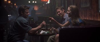 Movie still from “Joy Ride” (2001), directed by John Dahl – A group of people sitting around a table; Medium shot, Over the shoulder angle