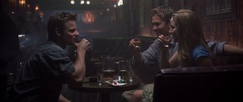 Movie still from “Joy Ride” (2001), directed by John Dahl – A group of people sitting at a table drinking; Medium shot, Over the shoulder angle