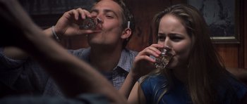 Movie still from “Joy Ride” (2001), directed by John Dahl – A man and a woman are drinking from glasses; Close Up shot, Over the shoulder angle