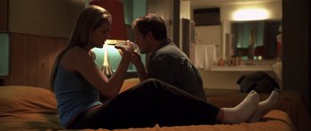 Movie still from “Joy Ride” (2001), directed by John Dahl – A man and a woman sitting on the floor; Medium shot, Low angle