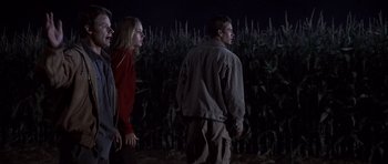 Movie still from “Joy Ride” (2001), directed by John Dahl – A man and a woman standing next to each other in a field; Wide shot, Low angle