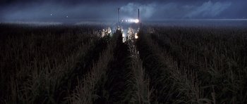Movie still from “Joy Ride” (2001), directed by John Dahl – A field with a truck driving down the middle of it at night; Extreme Wide shot, High angle