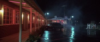 Movie still from “Joy Ride” (2001), directed by John Dahl – A car parked in front of a motel at night; Wide shot, Low angle
