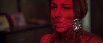 Movie still from “Joy Ride” (2001), directed by John Dahl – A woman wrapped in tape with her mouth taped shut; Close Up shot, Low angle
