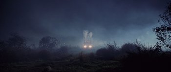 Movie still from “Joy Ride” (2001), directed by John Dahl – A car driving on a road in the fog; Extreme Wide shot, Low angle