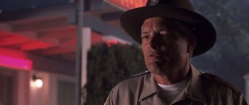 Movie still from “Joy Ride” (2001), directed by John Dahl – A man in a uniform is looking into the distance; Close Up shot, Low angle