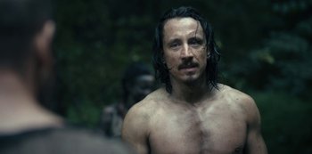 Movie still from “Barbarians” (2020), created by Arne Nolting – A man with long black hair and a mustache; Close Up shot, Over the shoulder angle