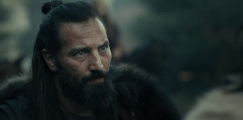 Movie still from “Barbarians” (2020), created by Arne Nolting – A man with a long beard and a fur coat; Close Up shot, Over the shoulder angle