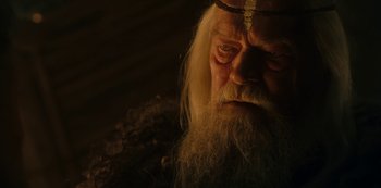 Movie still from “Barbarians” (2020), created by Arne Nolting – An old man with long white hair and a beard; Close Up shot, Low angle