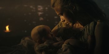 Movie still from “Barbarians” (2020), created by Arne Nolting – A woman holding a baby in her arms; Close Up shot, Over the shoulder angle