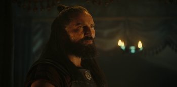 Movie still from “Barbarians” (2020), created by Arne Nolting – A man with long hair and a long beard; Close Up shot, Over the shoulder angle