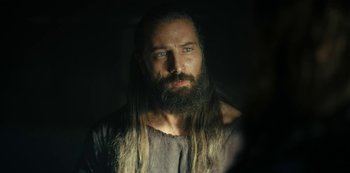 Movie still from “Barbarians” (2020), created by Arne Nolting – A man with long hair and a long beard; Close Up shot, Over the shoulder angle