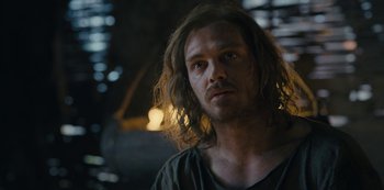 Movie still from “Barbarians” (2020), created by Arne Nolting – A person with long brown hair; Close Up shot, Over the shoulder angle