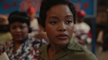 Movie still from “A League of Their Own” (2022), created by Abbi Jacobson – A person with short black hair; Close Up shot, Over the shoulder angle