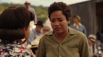 Movie still from “A League of Their Own” (2022), created by Abbi Jacobson – A woman in a green shirt talking to another woman; Close Up shot, Over the shoulder angle
