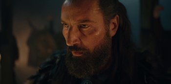 Movie still from “Barbarians” (2020), created by Arne Nolting – A person with long hair and a beard; Close Up shot, Low angle