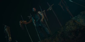 Movie still from “Barbarians” (2020), created by Arne Nolting – A man that is standing in the dark; Wide shot, Low angle