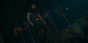 Movie still from “Barbarians” (2020), created by Arne Nolting – A man that is sitting in the dark; Medium shot, Low angle
