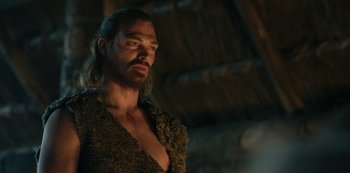 Movie still from “Barbarians” (2020), created by Arne Nolting – A person with long hair and a beard; Medium shot, Low angle