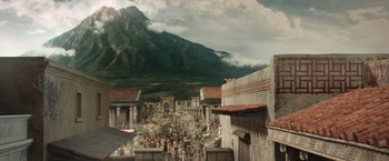 Movie still from “Pompeii” (2014), directed by Paul W.S. Anderson – An image of an ancient city with a mountain in the background; Extreme Wide shot, High angle