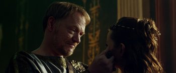 Movie still from “Pompeii” (2014), directed by Paul W.S. Anderson – A man and a woman looking into each others eyes; Close Up shot, Over the shoulder angle