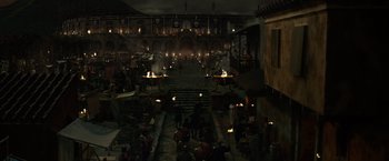 Movie still from “Pompeii” (2014), directed by Paul W.S. Anderson – A group of people sitting around in a building; Extreme Wide shot, High angle