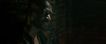 Movie still from “Pompeii” (2014), directed by Paul W.S. Anderson – A person looking at the camera; Close Up shot, Over the shoulder angle