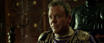 Movie still from “Pompeii” (2014), directed by Paul W.S. Anderson – A person wearing a costume; Close Up shot, Over the shoulder angle