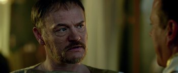 Movie still from “Pompeii” (2014), directed by Paul W.S. Anderson – A person with a beard; Close Up shot, Over the shoulder angle