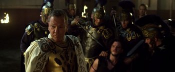 Movie still from “Pompeii” (2014), directed by Paul W.S. Anderson – A group of men dressed as roman legionnaires; Medium shot, Over the shoulder angle