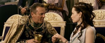 Movie still from “Pompeii” (2014), directed by Paul W.S. Anderson – A man and a woman sitting at a dinner table; Close Up shot, Over the shoulder angle