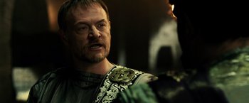 Movie still from “Pompeii” (2014), directed by Paul W.S. Anderson – A person wearing a costume; Close Up shot, Over the shoulder angle