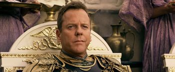 Movie still from “Pompeii” (2014), directed by Paul W.S. Anderson – A person sitting on a chair; Close Up shot, Over the shoulder angle