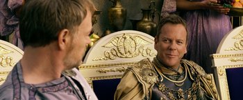 Movie still from “Pompeii” (2014), directed by Paul W.S. Anderson – Two men sitting in front of each other; Close Up shot, Over the shoulder angle