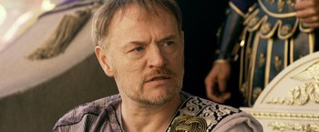 Movie still from “Pompeii” (2014), directed by Paul W.S. Anderson – A person with a beard and mustache; Close Up shot, Over the shoulder angle