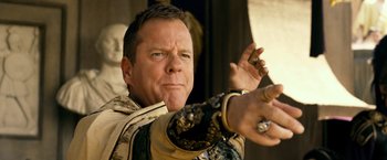 Movie still from “Pompeii” (2014), directed by Paul W.S. Anderson – A person holding a gun; Close Up shot, Low angle